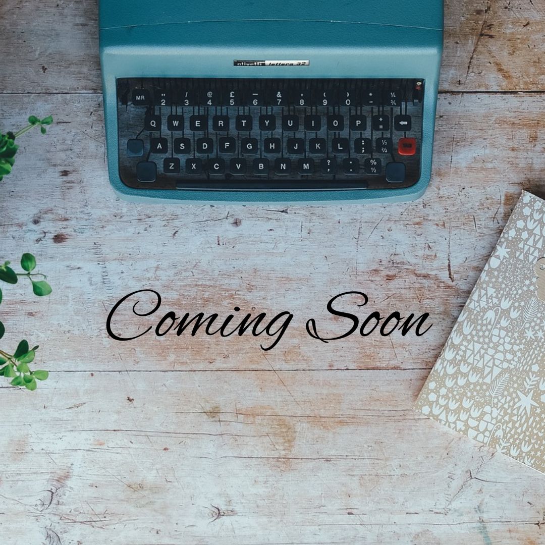 a blue typewriter on a wooden background with black text overlay stating the words coming soon.